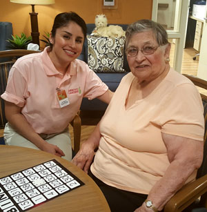 caregiver and elderly woman playing BINGO